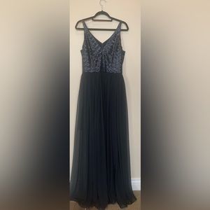 Long black formal maxi dress with a sequin top